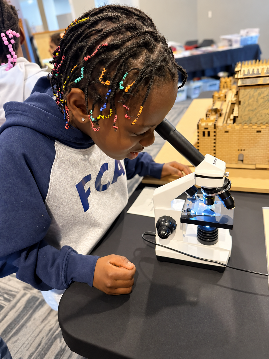 A student looking through a microscope